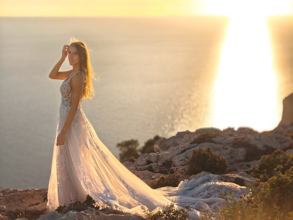 Beautiful blond bride posing on the dingli cliffs in Malta during golden hour